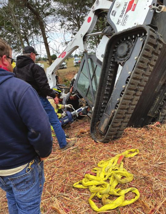 This photo shows the situation Brett Rohde and Dakota Murrow found as a man was pinned by a stump inside a flipped skid steer.