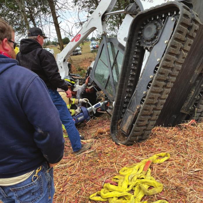 This photo shows the situation Brett Rohde and Dakota Murrow found as a man was pinned by a stump inside a flipped skid steer.