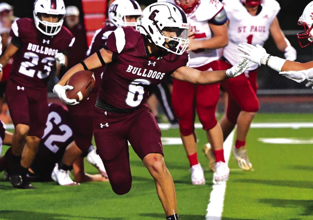 Caysen Perez makes his way around a stout St. Paul defense to bring the Bulldogs up to 27 against the Cardinals. Photo by Stephanie Steinhauser