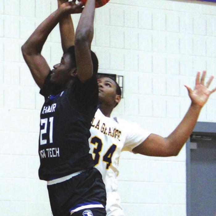La Grange’s Jaren Woods blocks the shot of Manor New Tech’s Houston Ifah in Friday’s game. Photo by Jeff Wick