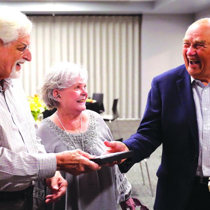 Harold “Hal” Stall, Dorothy Stall, and Harvey Hartman an original foundation member with a VHS video tape that Stall used to pitch fundraising for Space Center Houston. Photos by David Stall