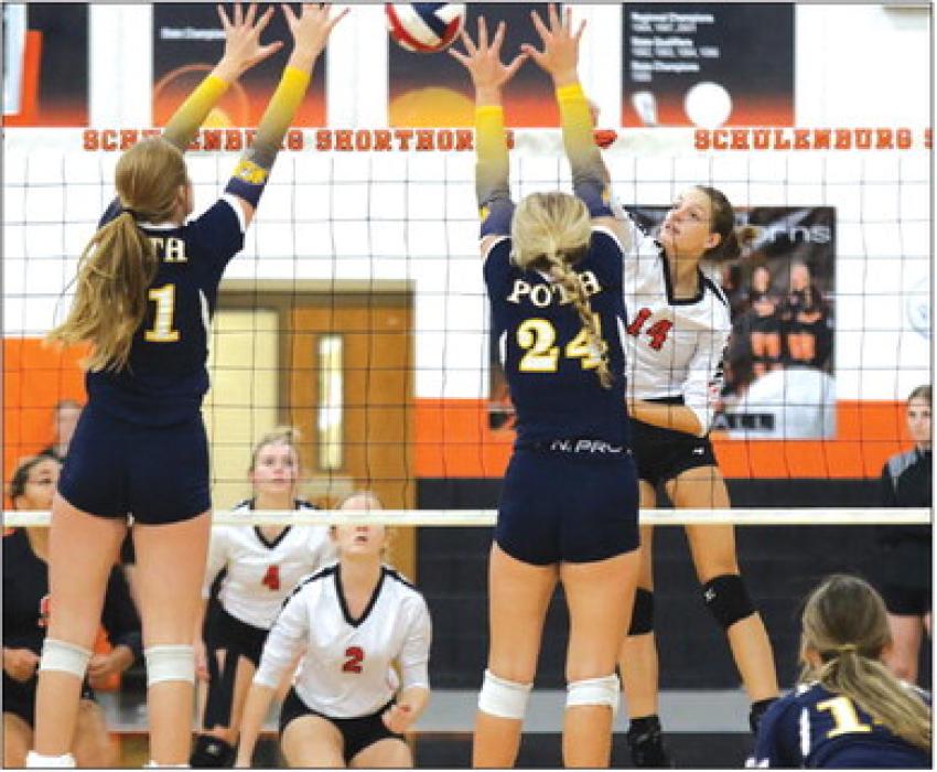 Schulenburg’s Emmrie Marx hits the ball over a pair of Poth blockers in Friday’s victory. Photo by Audrey Kristynik