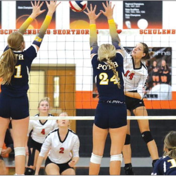 Schulenburg’s Emmrie Marx hits the ball over a pair of Poth blockers in Friday’s victory. Photo by Audrey Kristynik