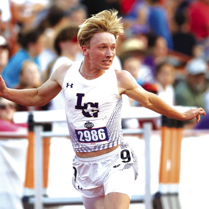 La Grange’s Austen Diggs leans at the finish line as he wins the 200 meter dash.