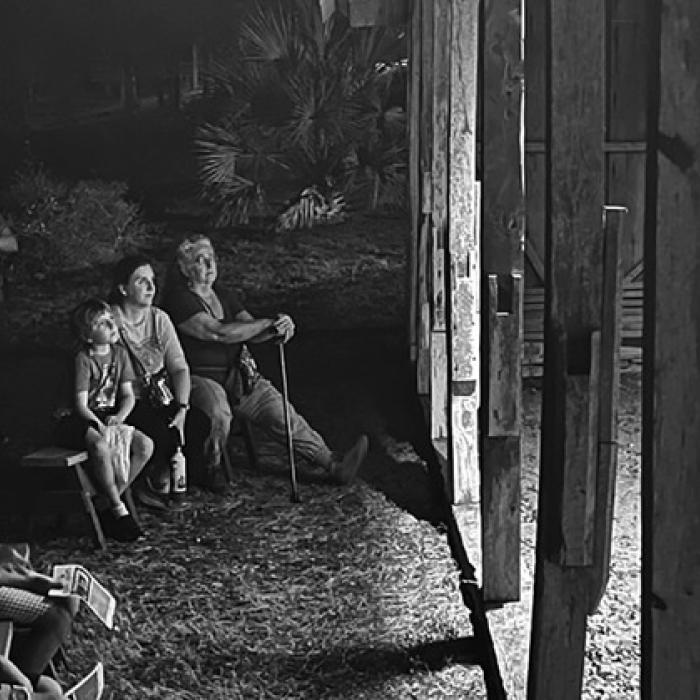 A captivated audience watches two FCCT actors perform a scene during a Memories of Monument Hill tour in 2024.