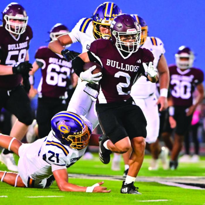 Zayden Perez breaks a tackle and picks up a first down for the Flatonia Bulldogs Friday. Photos by Stephanie Steinhauser
