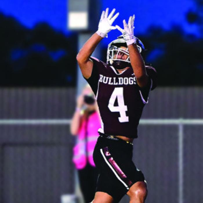 Jose Garcia catches a pass from quarterback Boston Targac for a Bulldog touchdown.