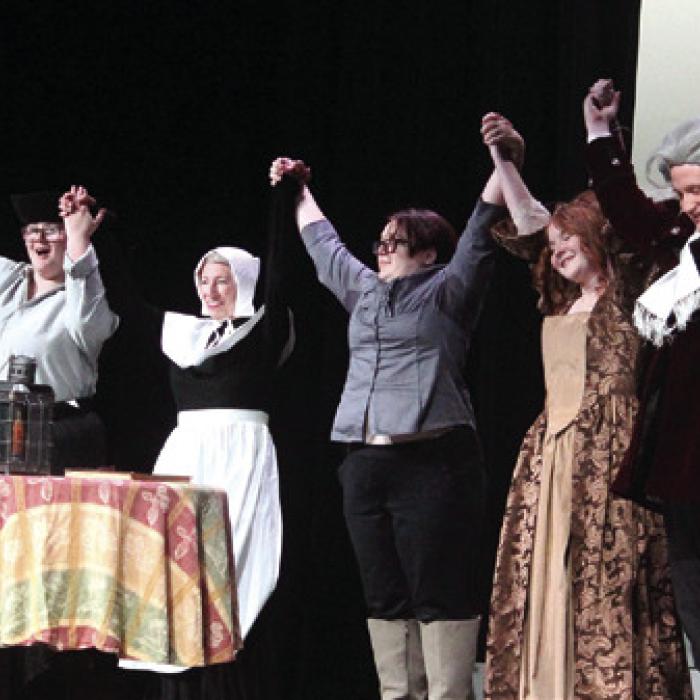 The cast and crew of the La Grange High School Drama Club celebrate with playwright and actress Mary Margaret Mann after Wednesday’s performance for the high school student body.