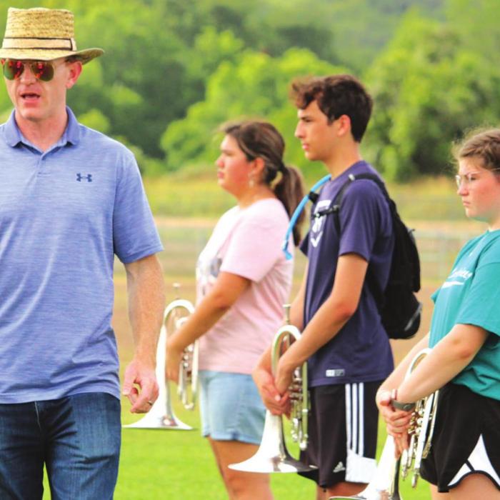 Director Chris Cooper speaks to the band, giving them directions for the next drill. Photo by MaKenzie Givan