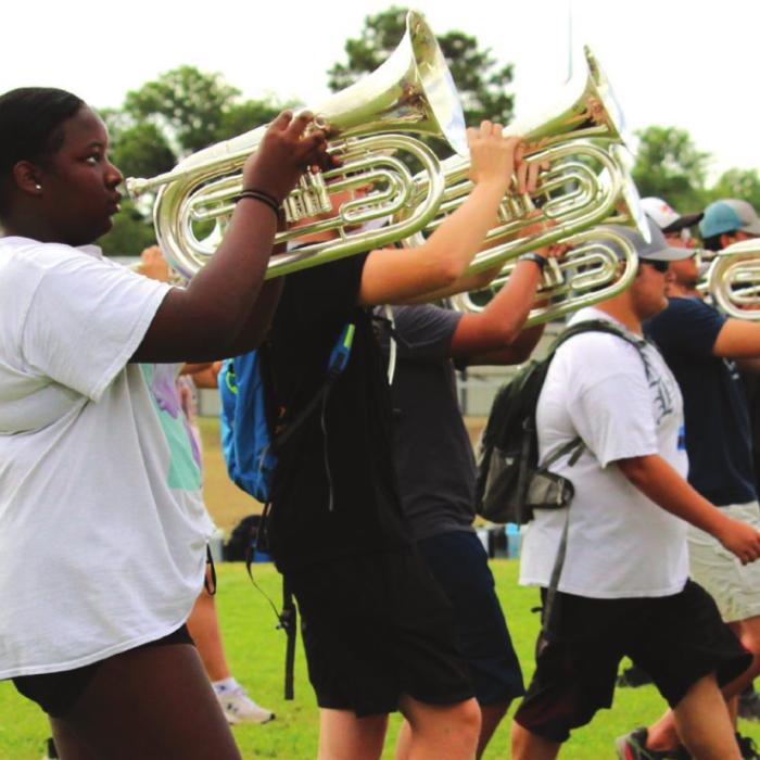 The baritone section holds their horns up as they march during outside rehearsals. Photos by MaKenzie Givan
