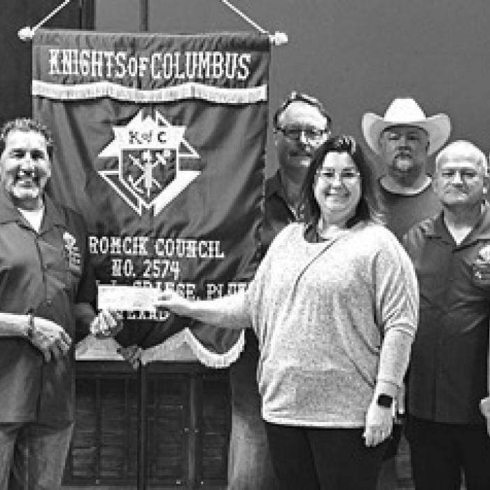 The Knights of Columbus presented $210 dollars to La Grange ISD for yearbooks for elementary, middle, and high school. Accepting the donation is Lucy Carr from Grand Knight Hector Cervantez.