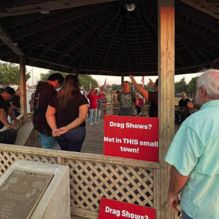 Left, a scene from inside Sengelmann Hall in Schulenburg Saturday night during the “Don’t Be A Drag” show. Right, a group of protesters gather for a prayer under the gazebo in downtown across North Main St. from Sengelmann Hall.