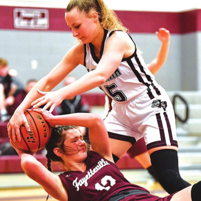 Fayetteville’s Kayme Schley fights to maintain possession as Flatonia’s Katherine Bruns tries take the ball in action at the Flatonia Tournament. Flatonia won 42-33. Photo by Stephanie Steinhauser