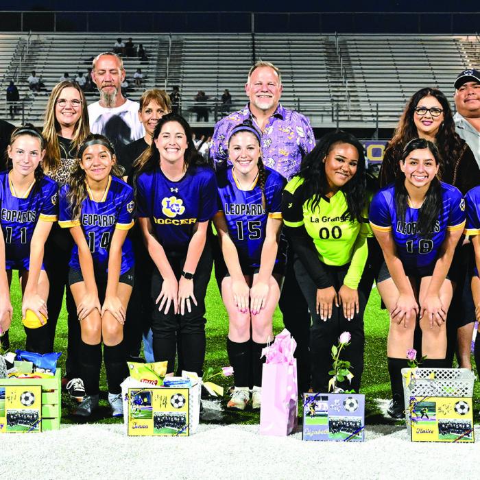 The seniors members of the La Grange soccer team were honored on the field with their parents prior to Tuesday’s home finale. Front row, left to right – Ellee Sodolak, Dulce Merlos, Evelyn Hernandez, Hailey Hill, Joana Lara, Head coach Lauren Hubbert, Elizabeth Hart, Hailee Burns, Gisela Portales, Karla De La Cruz and Hailee Martinez. Photo by Stephanie Steinhauser