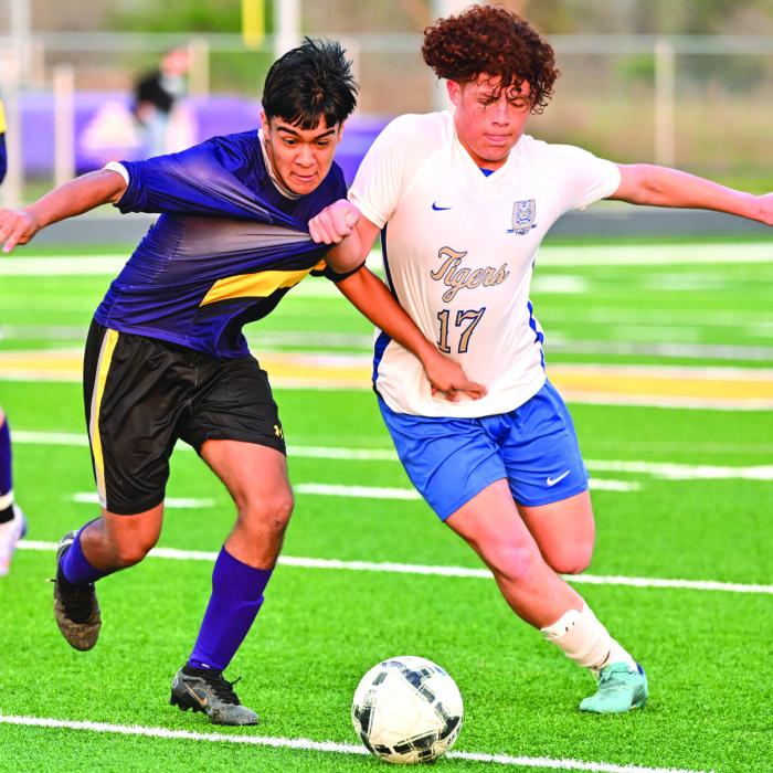 La Grange’s Edgar Monjaras fights his way to the ball even as a Rockdale player grabs a fistful of his jersey. Photo by Stephanie Steinhauser