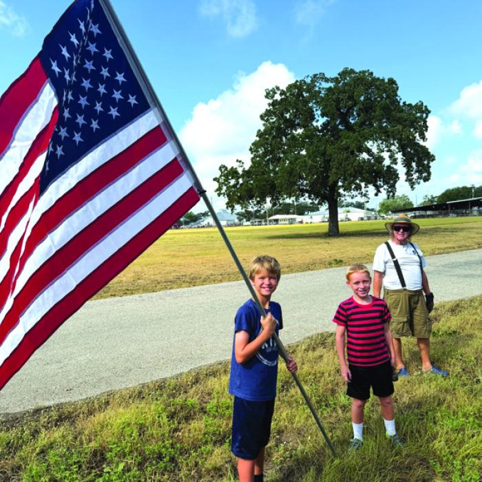 The tradition continues as Erich Lehmann and his sons Johann and Caleb, and Erich’s dad Mark helped put up the patriotic flags for the fair, lining Veterans Memorial Drive last week.
