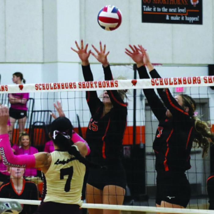 Schulenburg’s Kimber Bartosch, left, and Greenli Van Zandt, right, jump to block this hit by Danbury Friday. Photo by Audrey Kristynik