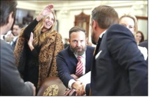 State Rep. Dustin Burrows (R-Lubbock) shakes hands with Rep. Jeff Leach (R-Plano) during opening day ceremonies on the House floor on Tuesday, Jan. 14. Bob Daemmrich for The Texas Tribune
