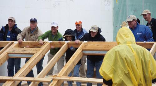 Former President Jimmy Carter and First Lady Rosalynn Carter (cener) help to raise a wall during the 27th Annual Habitat for Humanity Carter Work Project in Washington, D.C. in 2010. Photo from the U.S. National Archives