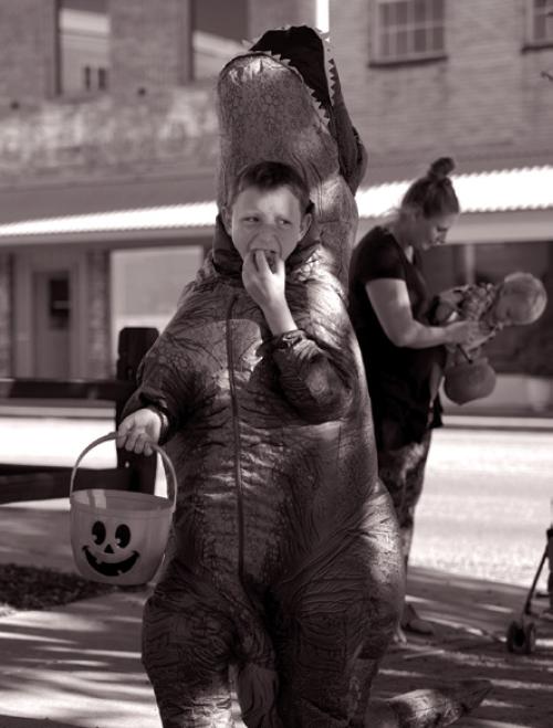 This trick-or-treating dinosaur in downtown La Grange didn’t waste any time taste testing. Photos by Tom Wood
