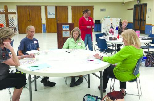 Fayette County retired teachers “studying” Bingo cards at May meeting.