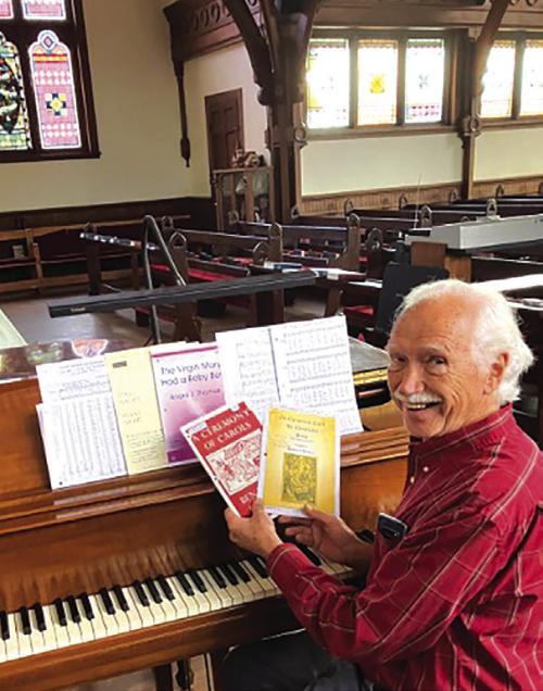 Don Kirby at the Steinway, planning the Christmas program.