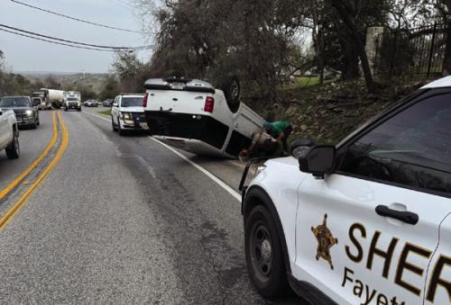 A white Ford SUV rolled over on the Bluff Friday morning, March 7. The driver was transported to South Austin Medical Center for treatment. Photo courtesy of the Fayette County Sheriff’s Office
