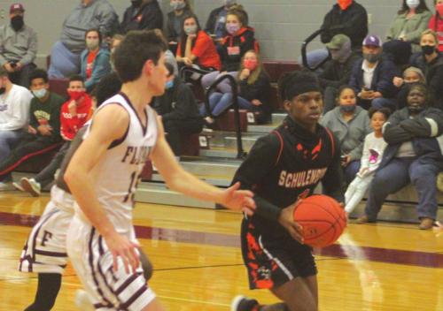 Schulenburg’s Kenny King dribbles the ball down the court against the defense of Flatonia’s Collin Bosl Saturday. Photo by Brian Pierson