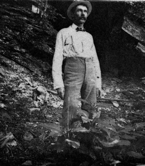 Frank Hausmann standing below the bluff, courtesy of the Fayette Heritage Museum and Archives.