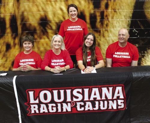 La Grange volleyball star Maddi Fritz officially signed a scholarship agreement to play for The University of Louisiana-Lafayette Wednesday. Standing behind is her high school coach Leslie Coltrain. Seated, left to right, are her brother Cole, mother Amy, Maddi, and her father Eric. Photo by Jeff Wick