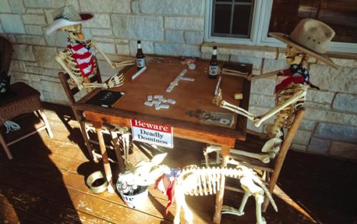 A pair of skeletons play a game of “Deadly Dominos” on the Tofels’ front porch. Photo by Andy Behlen