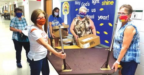 Staff members at Sacred Heart School in La Grange were masked-up and very busy last week as they were getting the campus prepared for the return of students Aug. 13.