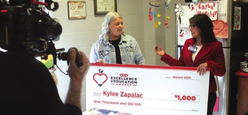 With cameras rolling Thursday, La Grange High School teacher Kylee Zapalac was informed she was a finalist for HEB’s Excellence in Education award and given a $1,000 check from Tamra Jones of HEB. Photo by Jeff Wick