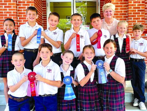 Pictured front from left: Gage Smrkovsky, Luke Goedrich, Rylee Wright, Kynslee Zapalac, Annaston Kutac; second row: Camila Saucedo, Jacob Schramek, Justin Schramek, Levi Johnson, John Schmidt, Briley Hartensteiner, Barett Redman; back row: Mrs. Paulette Valis, 4th grade Teacher.