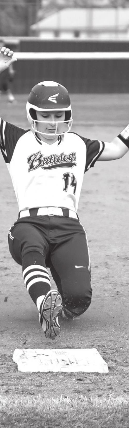 Katherine Bruns slides safely into third base in Tuesday night’s district game in Flatonia.