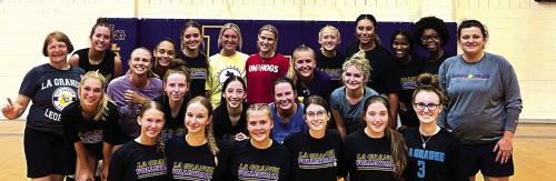 For the first time in the last three years, the La Grange volleyball team held an alumni game. Shown here are the varsity team members and the alumni members posing for a photo after Saturday’s match.