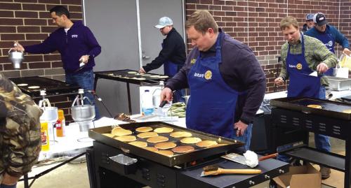 Rotary Club members will again be cooking thousands of flapjacks Thursday night for their annual Pancake Supper fundraiser. Here Josh Vandever, who will be Rotary president next year, and other Rotarians work the griddles at a previous year’s event.