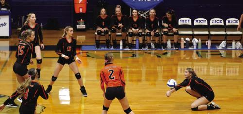 As her teammates look on, Schulenburg’s Haylee Vacek digs a ball in Tuesday’s victory at Rice Consolidated.