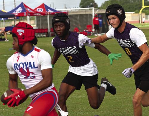 La Grange’s Skip Holmes, center, and Klayton Michalka, right, chase down this Brookshire Royal receiver Friday. Photo by Darrell D. Gest