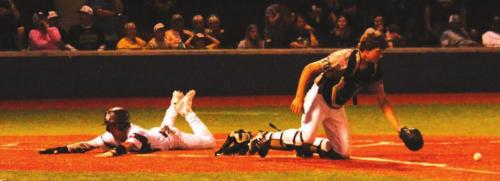 Fayetteville’s Travis Gully slides home with what would be the game-winning run Thursday. Photos by Jeff Wick