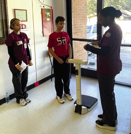 Victoria College Zelda L. Allen School of Nursing LVN Program nursing students (from left) Marcedes Martinez, Karsen Lacina with a St. Rose student.