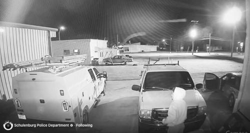 Surveillance video from a Schulenburg business shows one of the thieves just before they break into the work truck on the left early Monday morning, Dec. 29.
