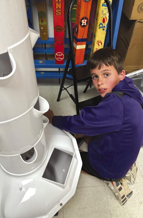 Hayes Kridel spent a day of his spring break helping put together the tower garden that had a spring cleaning.