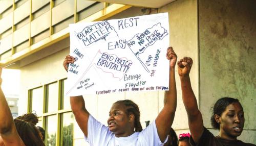 Diamond Houston holds up a sign as other protesters chant in front of Schulenburg City Hall at the Black Lives Matter demonstration in Schulenburg Wednesday evening, June 3. Photo by Andy Behlen