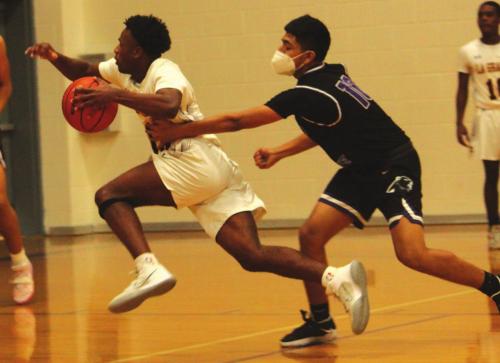 La Grange’s Dana Baker drives past a Austin player on his way to the basket Tuesday. Photo by Jeff Wick