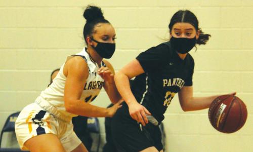 La Grange’s Kailee Jones plays defense against an Eastside guard in Tuesday’s game. Photo by Jeff Wick
