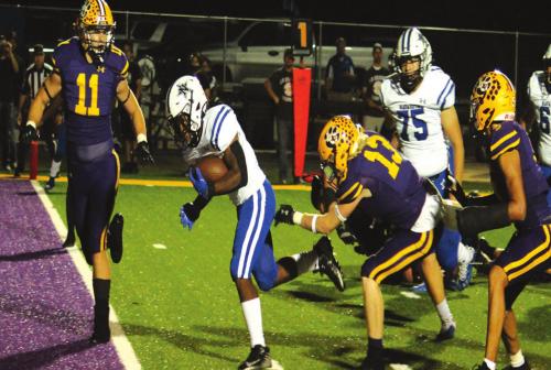 Navasota’s Jamall Thomas scores one of his two touchdowns Friday as La Grange’s Andrew Faske (11) and Justin Lewis (13) converge on the play. Photo by Jeff Wic