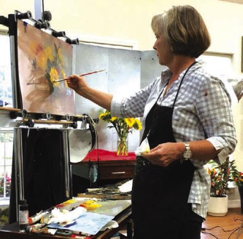 Fran Ellisor painting a still life in the studio.