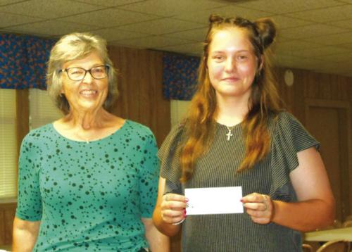 Round Top Hermann Sons Life Lodge 151 President, Linda Mattocks, presenting a check to 2023 scholarship recipient, McKinley Jasinski.