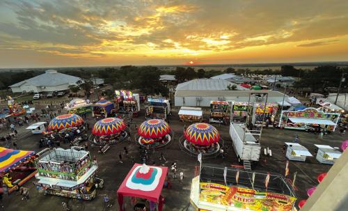 In this view from the top of the Ferris Wheel Thursday night, the sun sets over the Colorado River Valley on the first night of The Fayette County Fair in La Grange. Photo by Jeff Wick 